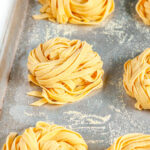 Homemade Pasta Dough Recipe nests on baking sheet