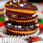 Dark Chocolate Peanut Butter Cups (Halloween Style!) with stack with sprinkles in white muffin liners and tray close up