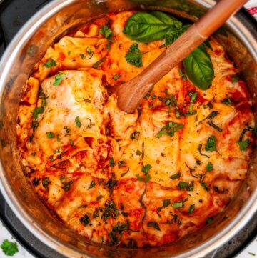 Instant Pot Turkey Vegetable Lasagna with wooden spoon and fresh basil