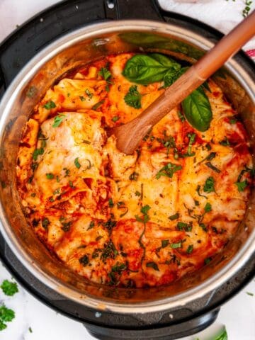 Instant Pot Turkey Vegetable Lasagna with wooden spoon and fresh basil