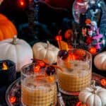 Pumpkin Bourbon Old Fashioned in whiskey glasses with Halloween Decorations