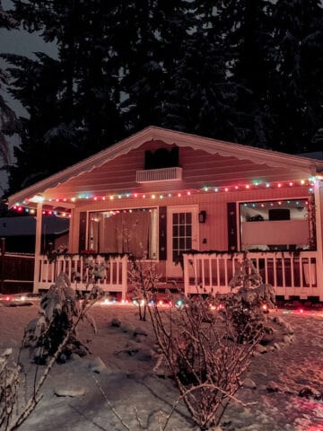 Happy Holidays! (Out of the Kitchen) Bavarian house with Christmas lights and snow on the ground at night