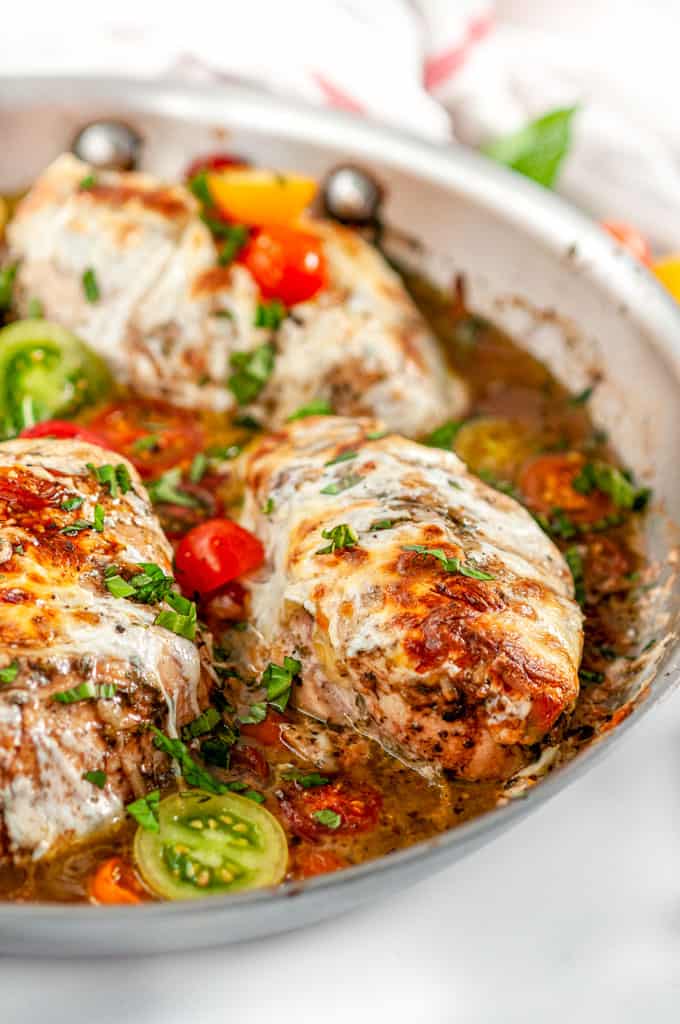Quick & Easy Skillet Chicken Caprese with cherry tomatoes and pan sauce in All-Clad Skillet close up