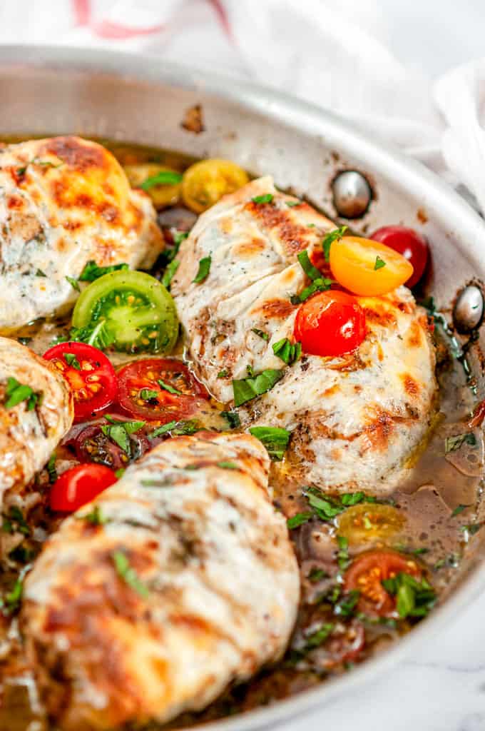 Quick & Easy Skillet Chicken Caprese with cherry tomatoes and pan sauce in All-Clad Skillet close up