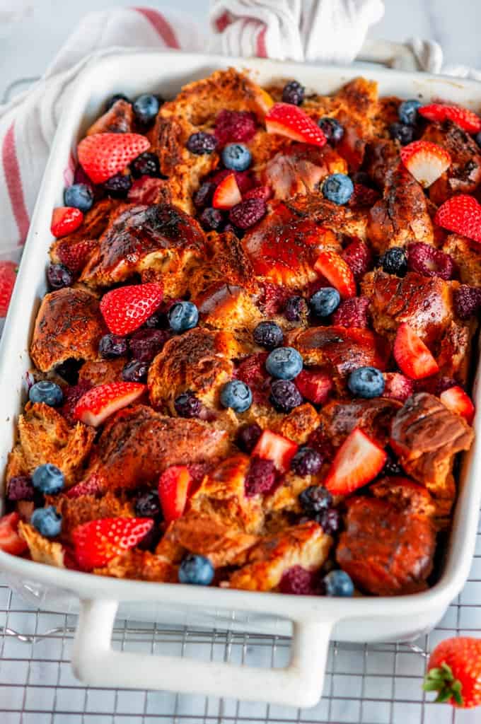Baked Overnight Berry French Toast in white casserole dish on wire rack