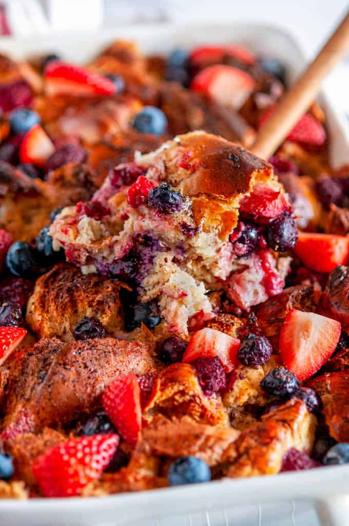 Baked Overnight Berry French Toast with wood spoon close up