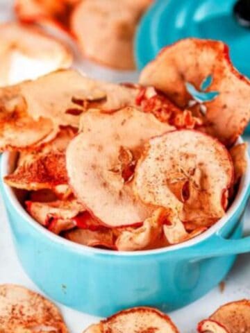 Healthy Baked Apple Chips in mini aqua blue cocette on white marble