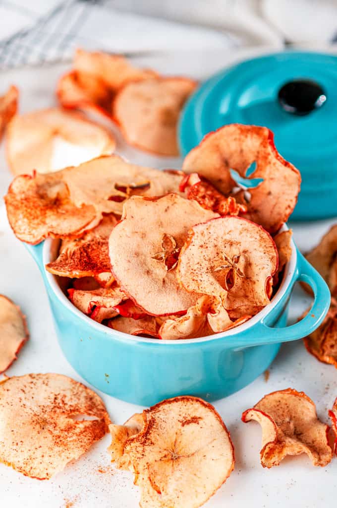 Healthy Baked Apple Chips in mini aqua blue cocette on white marble