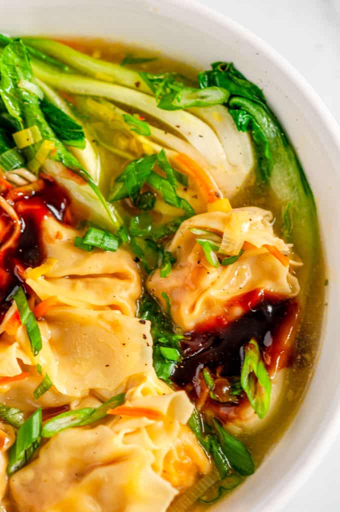 Quick 20 Minute Wonton Soup in white bowl on marble close up