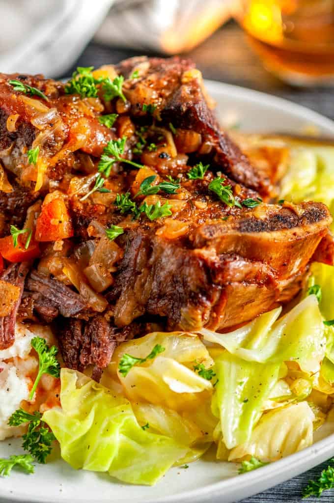 Instant Pot Whiskey Braised Short Ribs on gray plate mashed potatoes and cabbage close up