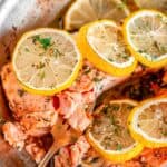 Skillet Lemon Dill Baked Salmon flaked with gold fork in All-Clad skillet