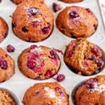 Easy Autumn Chai Spice Cranberry Muffins in muffin tin on white marble