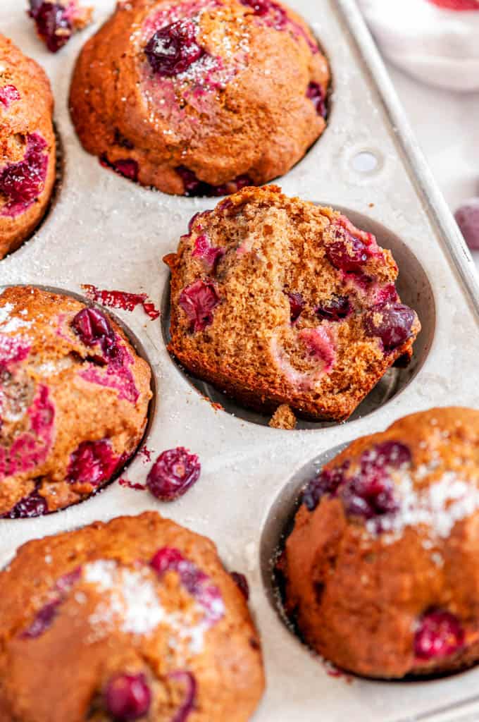 Easy Autumn Chai Spice Cranberry Muffins in muffin tin on white marble