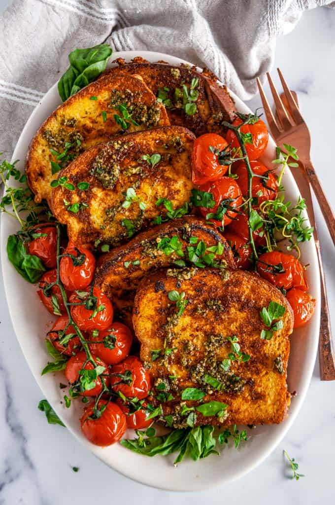 Easy Savory French Toast with cherry tomatoes and pesto on white plate