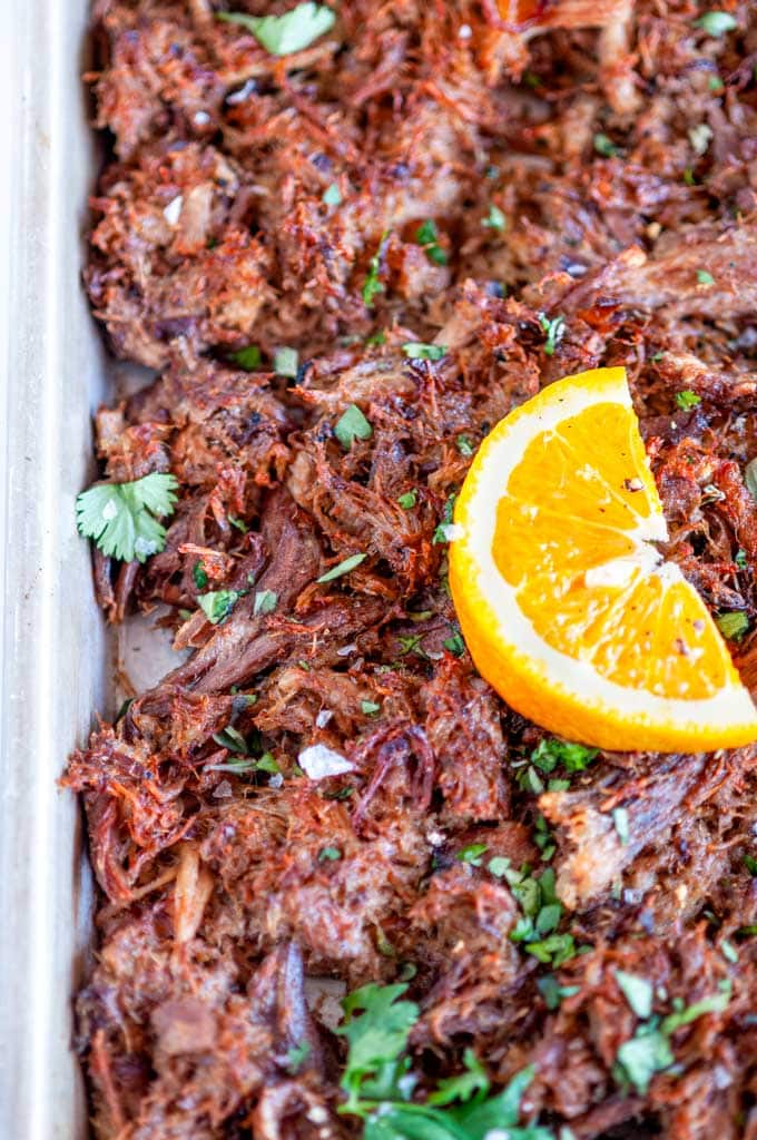 Cuban Inspired Instant Pot Pulled Pork on sheet pan with citrus slices