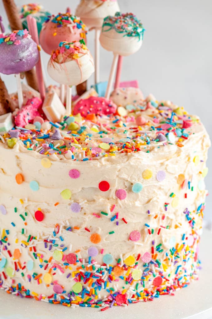 Birthday Surprise Confetti Cake with cake pops on white cake stand 