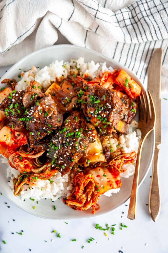 Instant Pot Korean Short Ribs on white plate with rice and kimchi