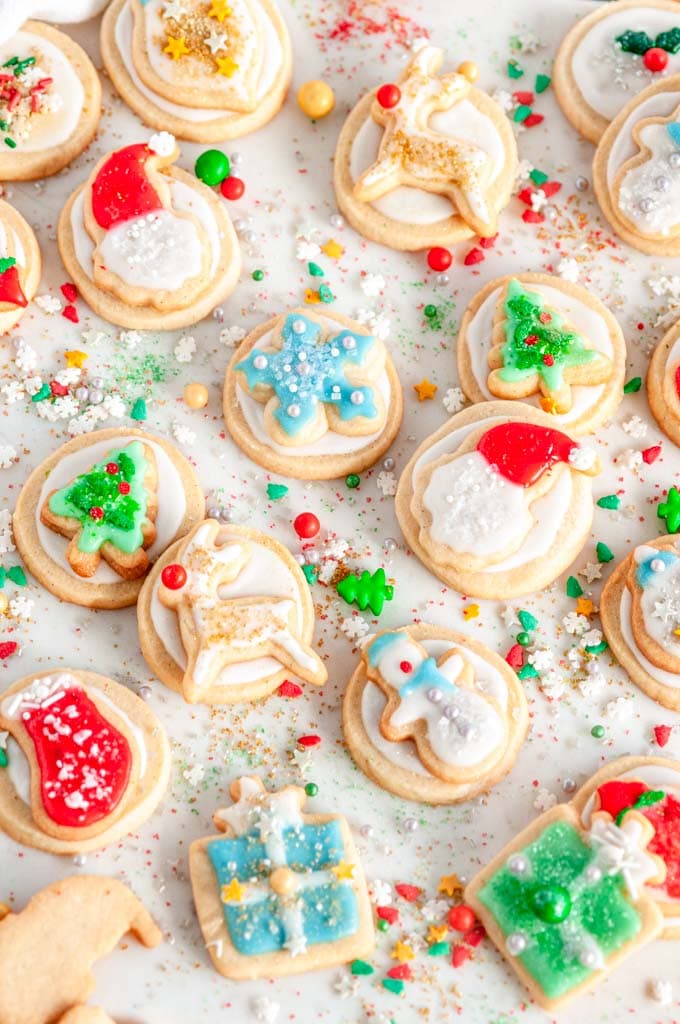 Holiday Sugar Cookies with Vanilla Icing with sprinkles on white marble
