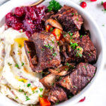 Instant Pot Red Wine Braised Short Ribs with mashed potatoes and cranberries in a white bowl