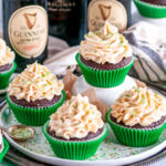 Guinness Chocolate Cupcakes with Baileys Buttercream Frosting in green liners topped with sanding sugar on white and gray plates