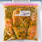 Four raw chicken breasts in a ziploc bag coated in a citrus marinade on white marble - purple rectangle overlay with white text