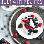 22 Festive Summer July 4th Recipes in white font on purple rectangle over photo of summer berries on white plate with limoncello whipped cream