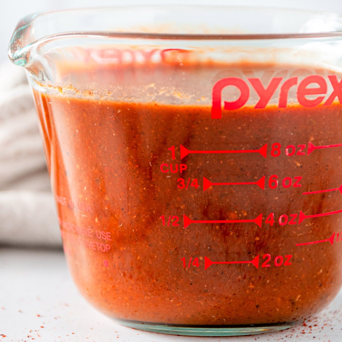 Pantry Friendly Enchilada Sauce in pyrex glass liquid measuring cup side view