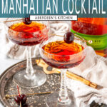 Classic Manhattan Cocktail in coupe glasses with maraschino cherries on gray plate with rye whiskey in background - teal rectangle overlay with white text