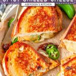 Spicy Grilled Cheese Sandwich sliced into halves with fresh jalapeno peppers on parchment paper - purple rectangle with white text overlay