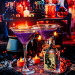 Halloween Hocus Pocus Cocktail in sugar rimmed martini glasses with potions in background