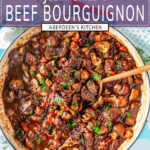 Julia Child's Beef Bourguignon in blue le creuset braiser with wooden spoon on white marble - purple rectangle with white text overlay