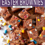 Easter brownies topped with cadbury mini eggs on white marble sliced overhead view