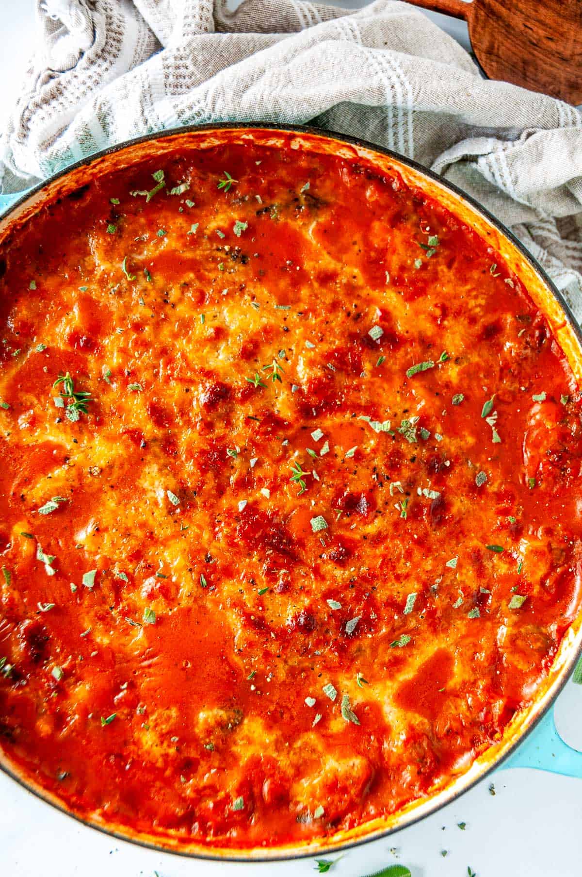 Bubbly one pot autumn gnocchi baked with Italian sausage and butternut squash, topped with golden melted cheese and fresh herbs