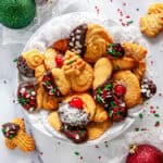 Italian Butter Cookies arranged in a festive bowl with chocolate-dipped cookies, sprinkles, and holiday decorations