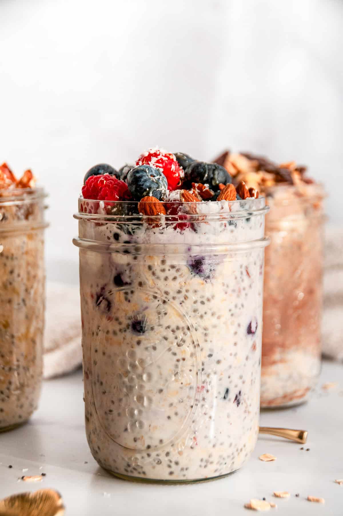 Easy overnight oats with mixed berries, almonds, and chia seeds in a mason jar