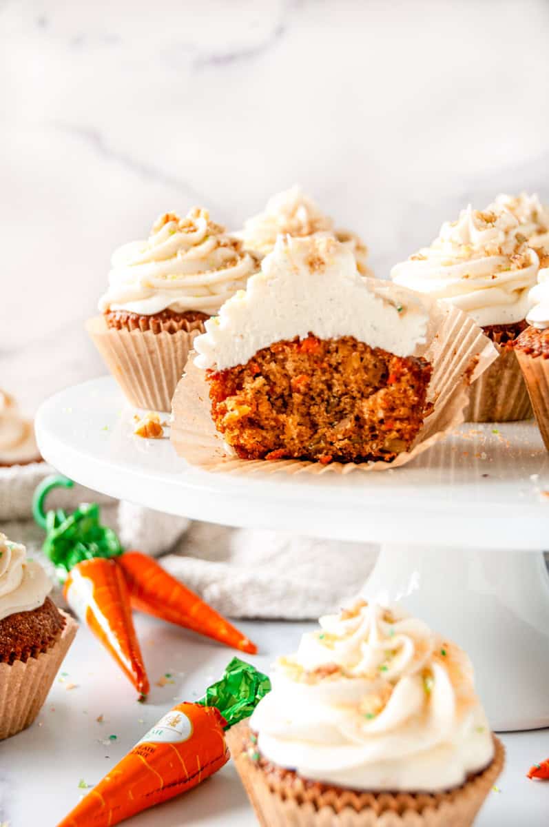 Carrot Cake Cupcake with a bite taken out showing soft, moist crumb and cream cheese frosting