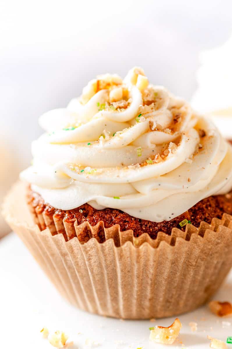 Carrot Cake Cupcake with cream cheese frosting in paper liner with soft blurred background