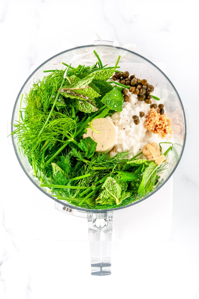 Bright, herby, and so simple! This green goddess dressing comes together in minutes in a blender or food processor with Greek yogurt, fresh herbs, lemon juice, and capers. A fresh and flavorful dressing, dip, or sauce for just about everything. From aberdeenskitchen.com #aberdeenskitchen #greengoddessdressing #greengoddessdip #protein #recipe #creamy #easy #processor #blender